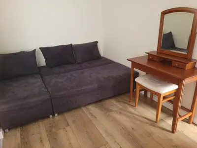 a living room with a couch and a table and a mirror at KĄCIK Apartament in Kraków