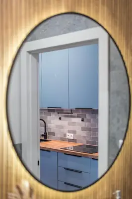 a mirror reflection of a kitchen with a sink at Kraków Główny Apt - Top Location, Park&Tram nearby - by Rentujemy in Kraków