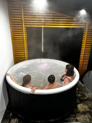 a group of people in a jacuzzi tub at Domek na Dogalu in Filipowice