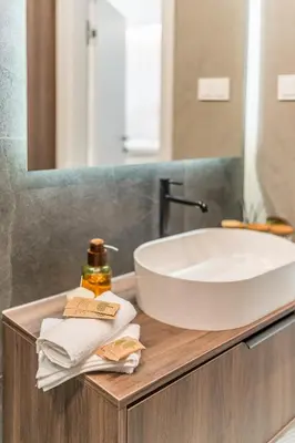 a bathroom with a white sink and a mirror at Kraków Prestige Suites - 61m2, Parking, Balcony, Workspace, AC - by Rentujemy in Kraków