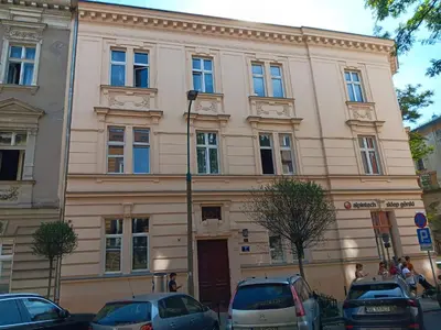a large building with cars parked in front of it at Apartament Róży in Kraków
