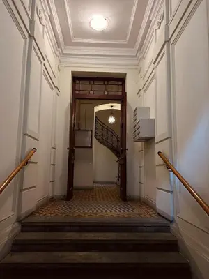 an empty hallway with stairs in a building at Apartament Róży in Kraków