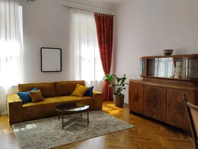a living room with a couch and a table at Apartament Róży in Kraków