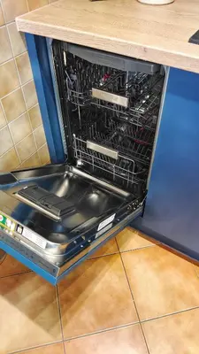 a dishwasher with its door open in a kitchen at Bronowicka Comfort Apartment in Kraków