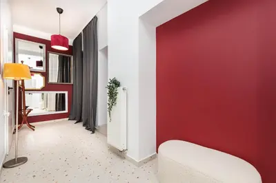 a living room with a red accent wall at Retro Glamour with a Modern Edge - by Upstairs in Kraków