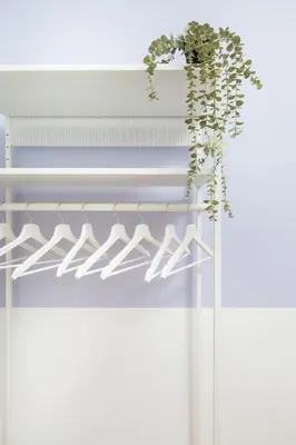 a plant hanging on a white shelf at Retro Glamour with a Modern Edge - by Upstairs in Kraków