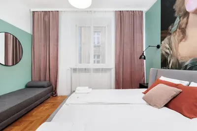a bedroom with a bed and a couch at Retro Glamour with a Modern Edge - by Upstairs in Kraków