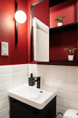 a bathroom with a white sink and red walls at Retro Glamour with a Modern Edge - by Upstairs in Kraków