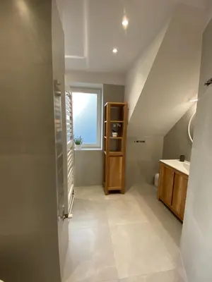a bathroom with a sink and a toilet and a window at Apartamenty Lawenda in Kraków