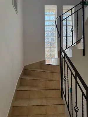 a staircase with wooden floors and a window at Apartamenty Lawenda in Kraków