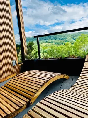 a balcony with a large window with a view at Black Deer - z Sauną na Tarasie, Jacuzzi i Widokiem na Góry - by Deer Hills Luxury Apartments in Kocoń