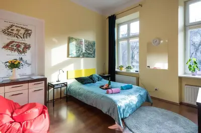 a bedroom with a bed and a chair in it at Colour-Box Studio, Wawel Castle Area in Kraków