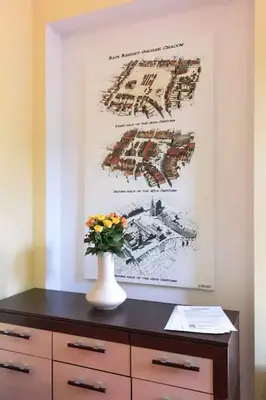 a vase of flowers sitting on a dresser with a painting at Colour-Box Studio, Wawel Castle Area in Kraków