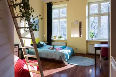 a bedroom with a bunk bed and a ladder at Colour-Box Studio, Wawel Castle Area in Kraków