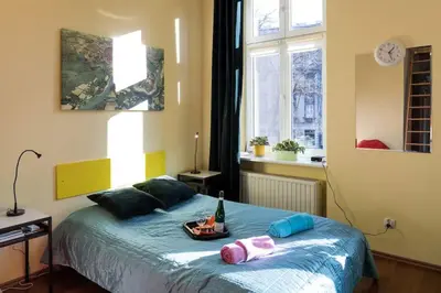 a bedroom with a bed with a bottle of wine on it at Colour-Box Studio, Wawel Castle Area in Kraków