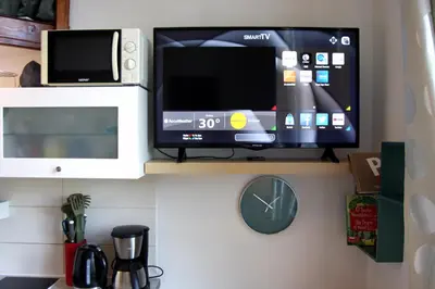 a flat screen tv sitting on a shelf at Smallest Spot in Town, City Center in Kraków