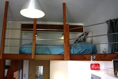a bunk bed in a room with a light at Smallest Spot in Town, City Center in Kraków