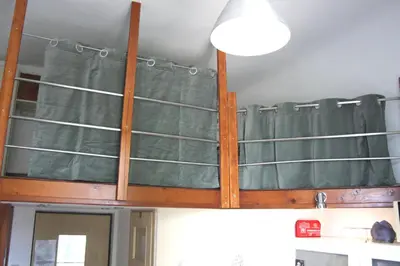 a bunk bed in the ceiling of a room at Smallest Spot in Town, City Center in Kraków