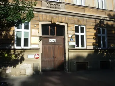 a wooden door on the side of a building at Smallest Spot in Town, City Center in Kraków