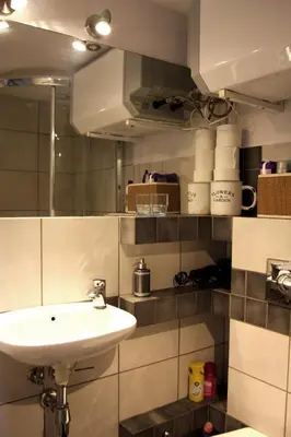 a bathroom with a sink and a mirror at Smallest Spot in Town, City Center in Kraków