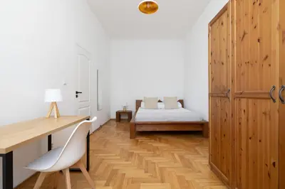 a bedroom with a bed and a desk and a table at 1-bedroom Apartment - Radziwiłłowska 14 Street in Kraków