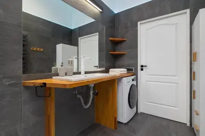 a bathroom with a sink and a washing machine at 1-bedroom Apartment - Radziwiłłowska 14 Street in Kraków