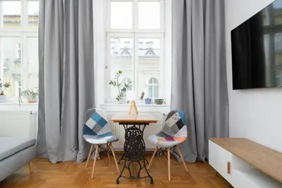 a living room with a table and two chairs at 1-bedroom Apartment - Radziwiłłowska 14 Street in Kraków