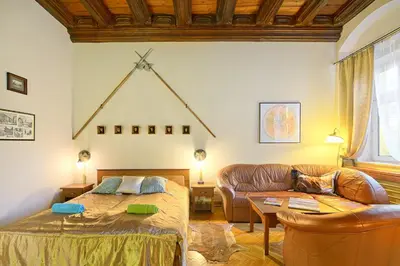 a living room with a bed and a couch at Knights&Lords Apartment, Old Town in Kraków