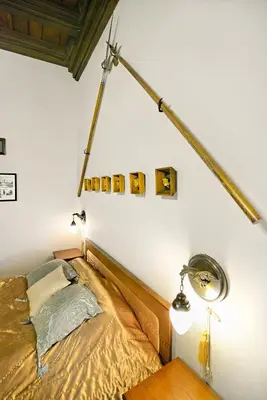 a bedroom with a bed and a lamp on the wall at Knights&Lords Apartment, Old Town in Kraków