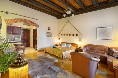 a living room with a bed and a couch at Knights&Lords Apartment, Old Town in Kraków