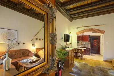 a large mirror in a living room with a couch at Knights&Lords Apartment, Old Town in Kraków