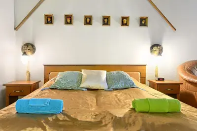 a bedroom with a bed with two pillows on it at Knights&Lords Apartment, Old Town in Kraków
