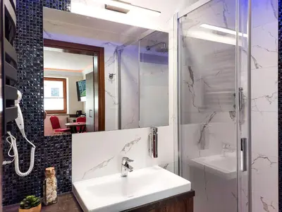 a bathroom with a sink and a shower at Beskidia - Noclegi w Beskidach in Roczyny
