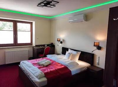 a bedroom with a bed with green lights on it at Beskidia - Noclegi w Beskidach in Roczyny