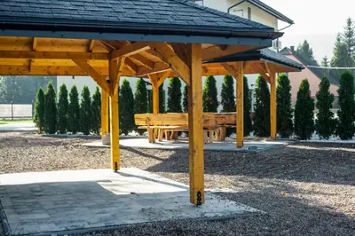 a wooden pavilion with a picnic table in a park at Beskidia - Noclegi w Beskidach in Roczyny