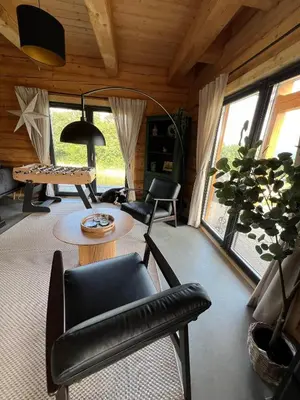 a living room with a table and chairs at Kowalowa Chata Zawoja in Zawoja