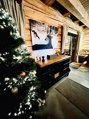 a christmas tree in a room with a tv at Kowalowa Chata Zawoja in Zawoja