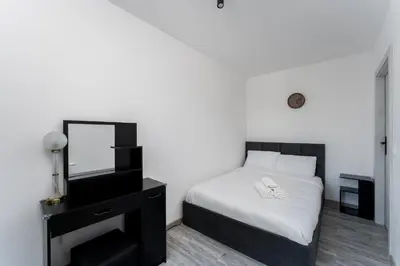 a bedroom with a bed and a mirror and a dresser at Gusta Cosy Apartment by BookingHost in Kraków