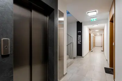 a corridor of an office building with a hallway at Gusta Cosy Apartment by BookingHost in Kraków