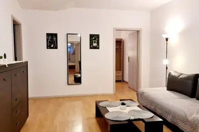 a living room with a couch and a table at Przestronny pokój w mieszkaniu na Filipa in Kraków