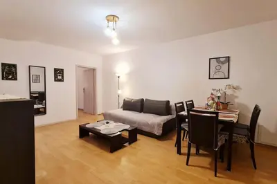 a living room with a couch and a table at Przestronny pokój w mieszkaniu na Filipa in Kraków