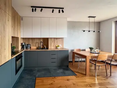 a kitchen with a table and a dining room at Grey Wall Apartment Kraków in Kraków