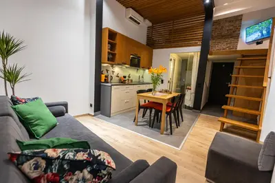 a living room with a couch and a table at Vintage Bracka 6 Apartment in Kraków