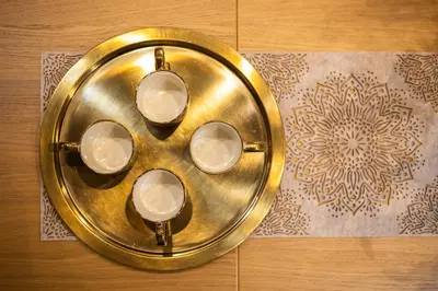 a gold plate with four plates on a table at Vintage Bracka 6 Apartment in Kraków