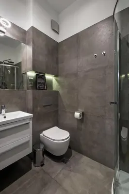 a bathroom with a toilet and a sink at Discover Krakow Apartments - Lubicz St - Loft - Next to Main Station, AC in Kraków