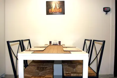 a white table with chairs and a picture on the wall at Apartment San Sebastian, City Center in Kraków