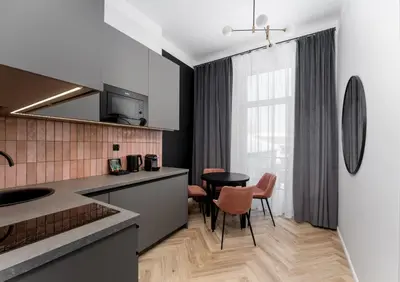 a kitchen with a table and a dining room at Wawel Apartments - Old Town in Kraków