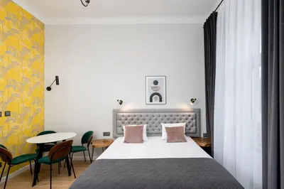 a bedroom with a bed and a table and chairs at Wawel Apartments - Old Town in Kraków