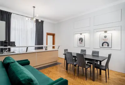a living room with a green couch and a table at Wawel Apartments - Old Town in Kraków