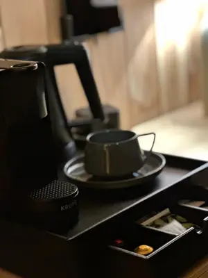 a coffee maker and a cup on a counter at Brown Deer - z Sauną na Tarasie, Jacuzzi i Widokiem na Góry - by Deer Hills Luxury Apartments in Kocoń